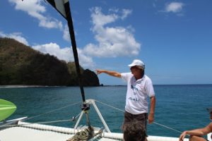 Captain Markus Grundmann of the catamaran Picante on Tobago in Trinidad and Tobago in the Caribbean explains the sailing boat and the tour of the day trip for snorkeling